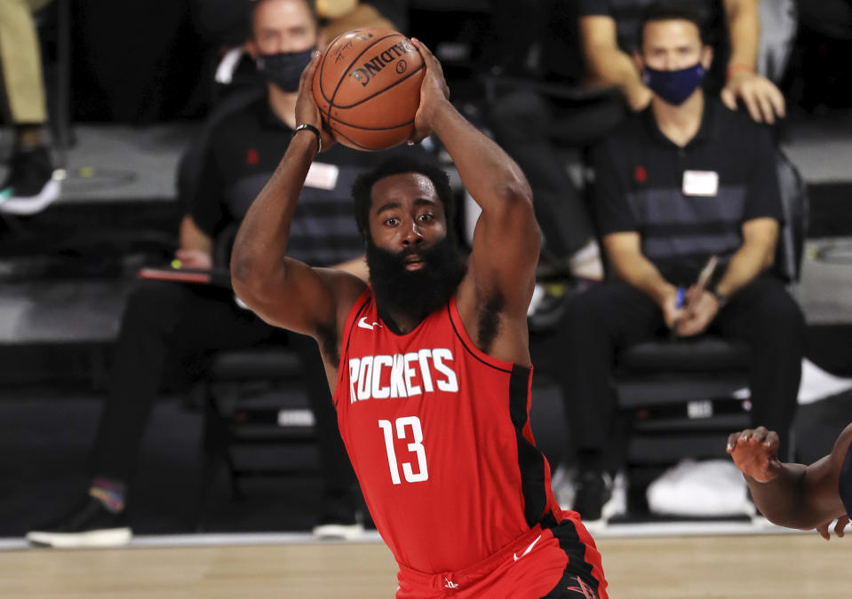 Houston Rockets James Harden (13) handles the ball against the Dallas Maverick during the first half of an NBA basketball game Friday, July 31, 2020, in Lake Buena Vista, Fla. (Mike Ehrmann/Pool Photo via AP)