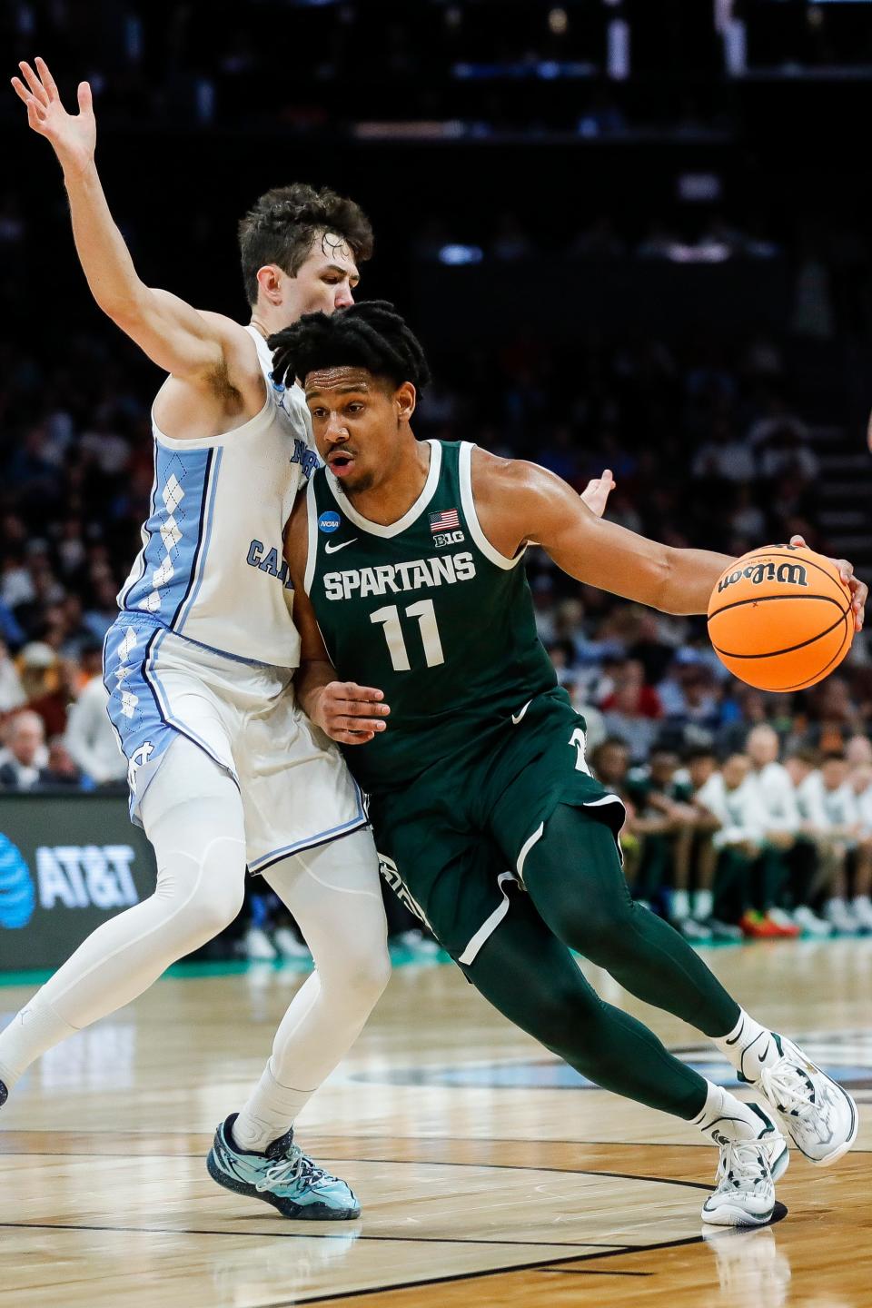 Michigan State guard AJ Hoggard (11) dribbles past North Carolina guard Cormac Ryan (3) during the first half of the second round of the NCAA Tournament West Region at the Spectrum Center in Charlotte, NC , on Saturday, March 23, 2024.