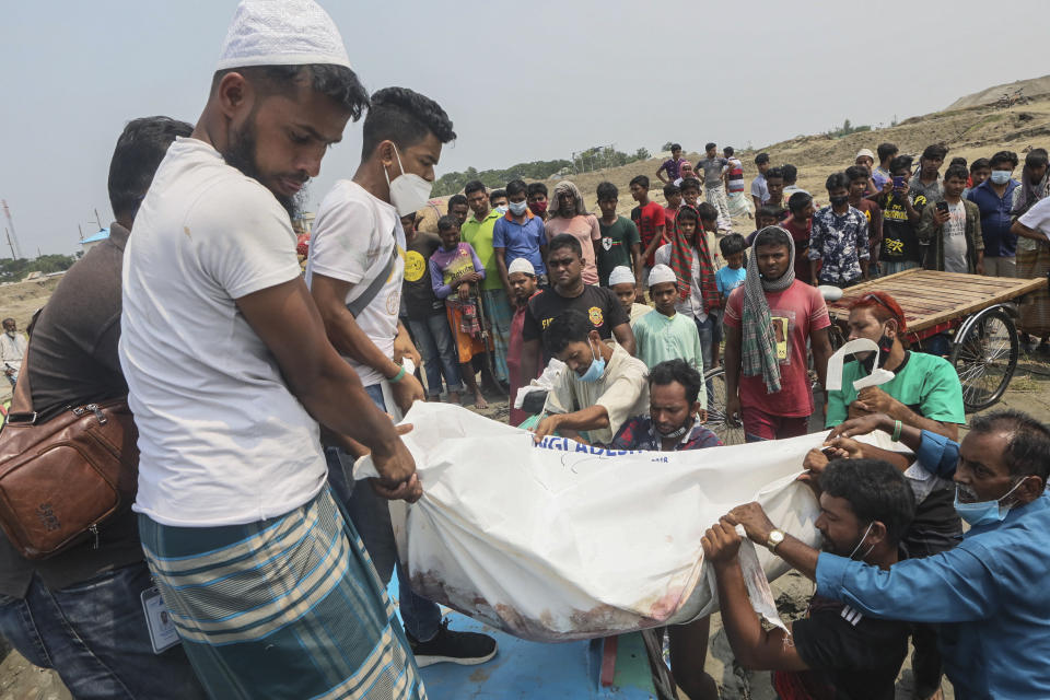 The body of a victim is carried after a speedboat overturned Monday morning after hitting a cargo boat in River Padma at the Kanthalbari ferry terminal in Madaripur, central Bangladesh, Monday, May 3, 2021. More than two dozen people were killed. (AP Photo/Abdul Goni)