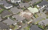 This image taken from a video shows a damaged home following a gas explosion in Christchurch, New Zealand Friday, July 19, 2019. Several people were injured and dozens of homes evacuated in the New Zealand city of Christchurch on Friday after a huge gas explosion destroyed one home and damaged others. (NEWSHUB via AP)