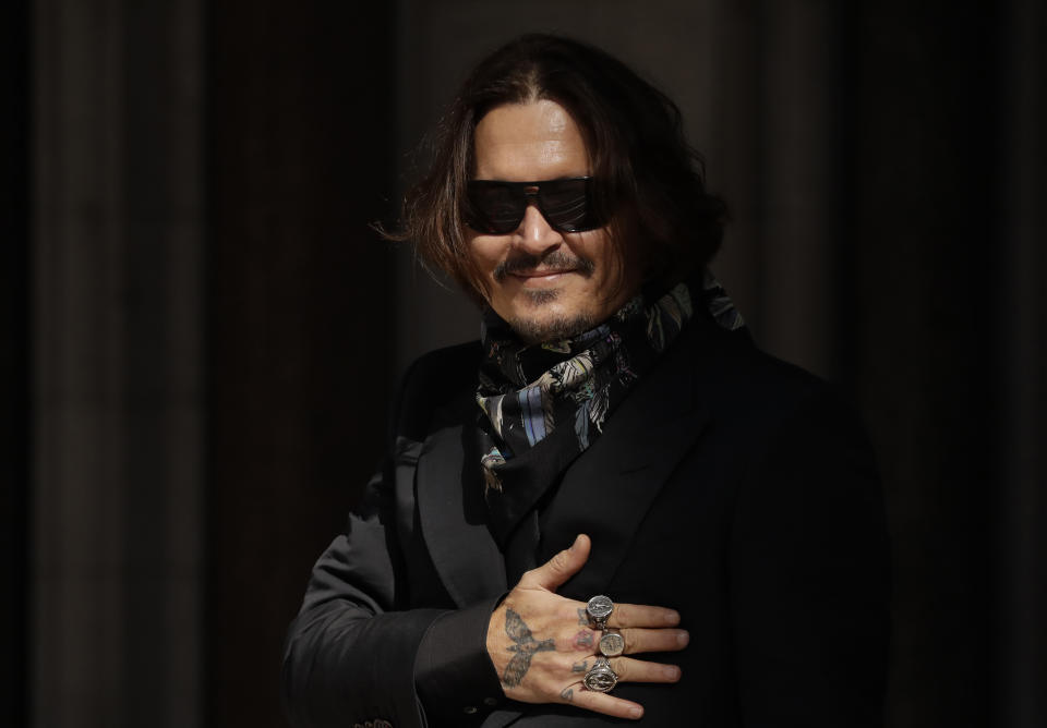 Actor Johnny Depp arrives at the High Court in London, Monday, July 20, 2020. Amber Heard started Monday to give evidence at the High Court in London as part of Johnny Depp’s libel case against The Sun over allegations of domestic violence during the couple's relationship. (AP Photo/Matt Dunham)