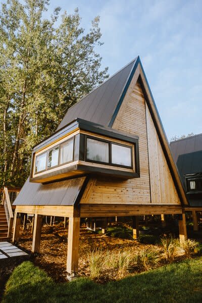 The one-bedroom A-frames are connected by a 350-foot walkway along the backside of the cabins. Each unit has access to a private hot tub.