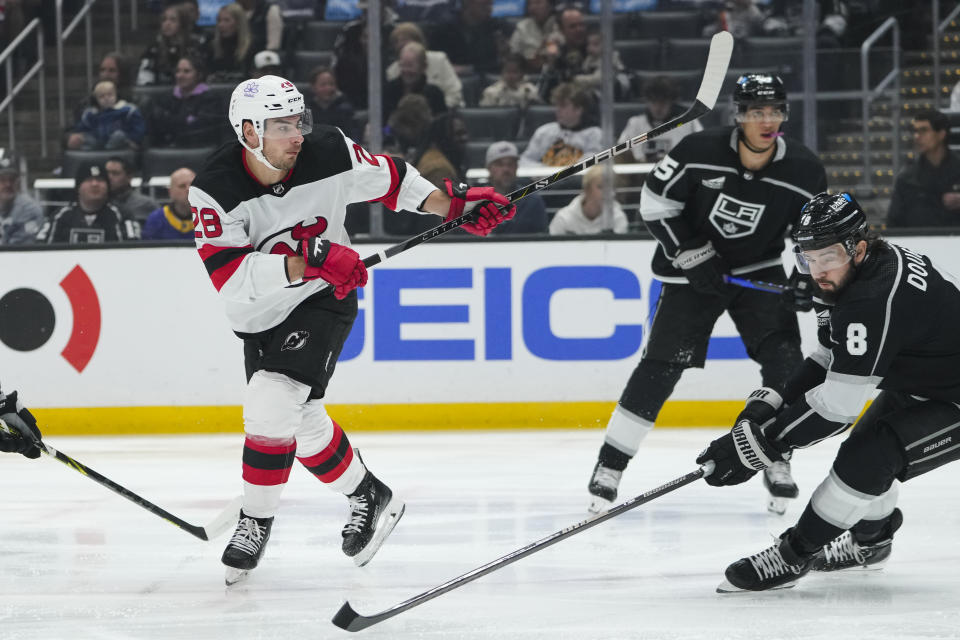 New Jersey Devils right wing Timo Meier shoots to score past Los Angeles Kings defenseman Drew Doughty (8) during the first period of an NHL hockey game, Sunday, March 3, 2024, in Los Angeles. (AP Photo/Ryan Sun)