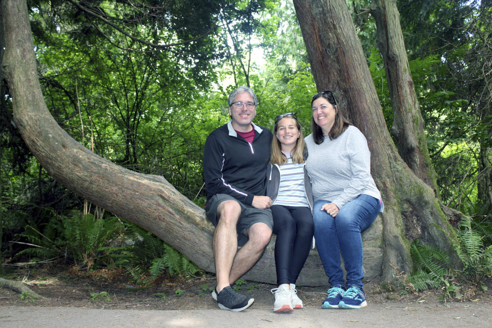 Barry Kluczyk, left, poses with his family, Mary Kluczyk, center, and Carrie Kluczyk on a hiking trail in the Dungeness National Wildlife Refuge, near Sequim, Wash., in 2021, during a Seattle-based mini sabbatical. (Barry Kluczyk via AP)