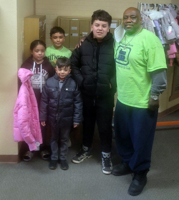 Halfway Home Founder William Wright (far right) is photographed with students (from left) Miguel Hernandez, Isabelle Hernandez, Diego Hernandez and Isaac Ruvalcaba. The nonprofit will start accepting toys Monday for the Dec. 21 toy giveaway at the nonprofit.