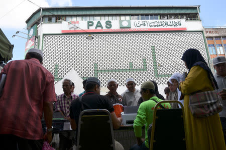 People crowd outside the Party Islam Se-Malaysia (PAS) headquarters in Kota Bharu, Kelantan, Malaysia April 13, 2018. REUTERS/Stringer