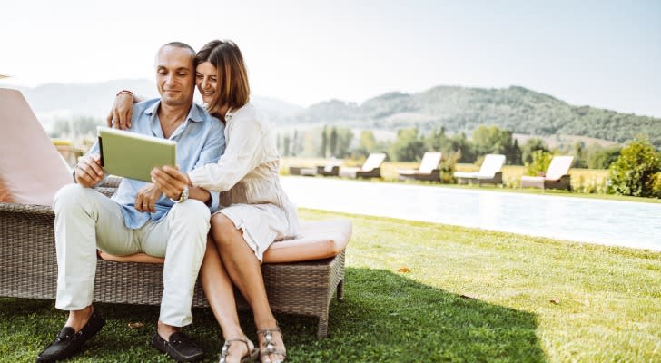 An ultra-high-net-worth couple looking at an itinerary.