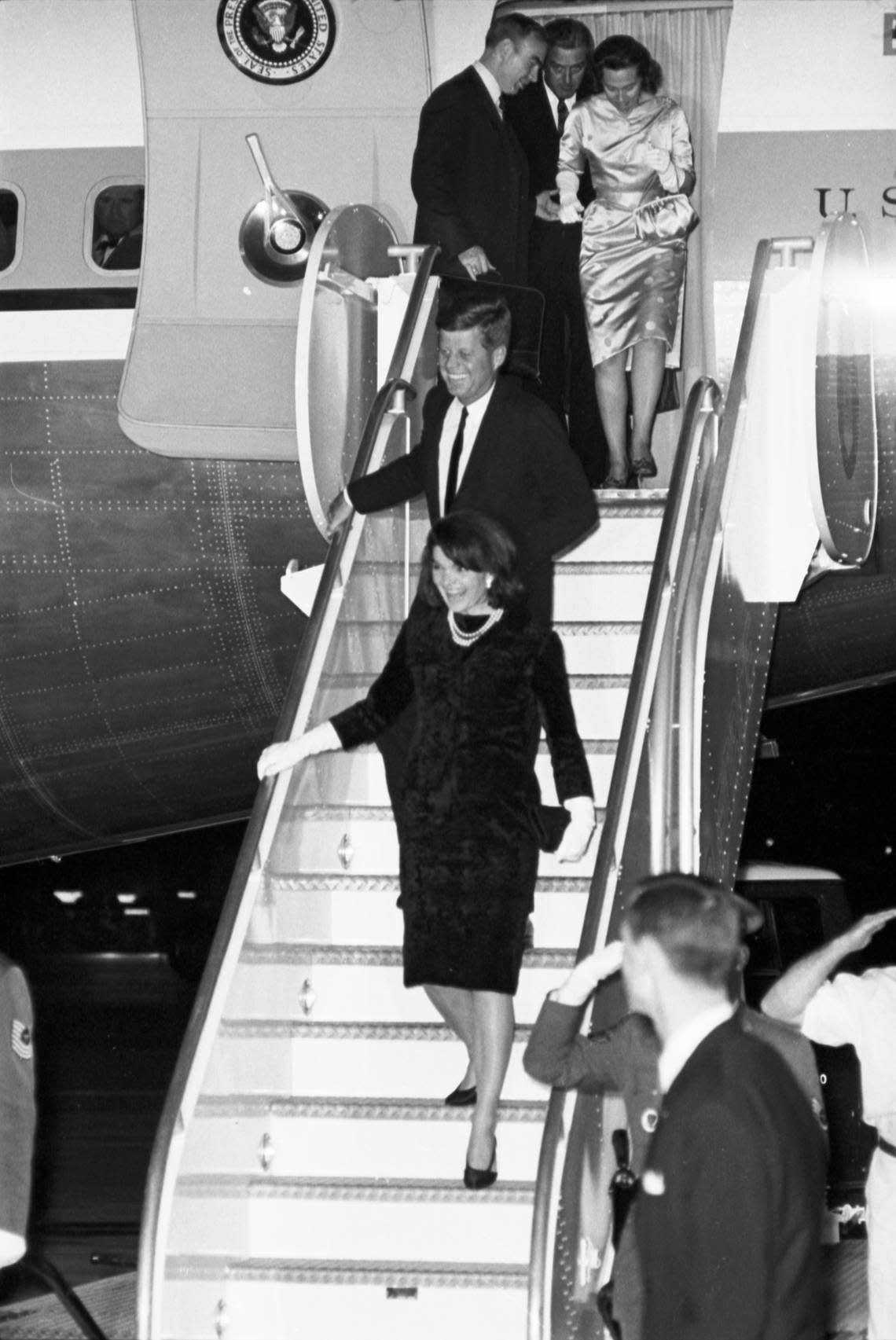 President John F. Kennedy and Jackie Kennedy descending from Air Force One at Carswell Air Force Base. Congressman Jim Wright, Gov. John Connally and Mrs. Connally seen in the doorway. Nov. 21, 1963