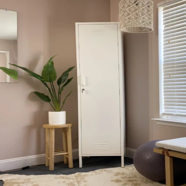 a tall shelved storage cabinet in the corner of a room