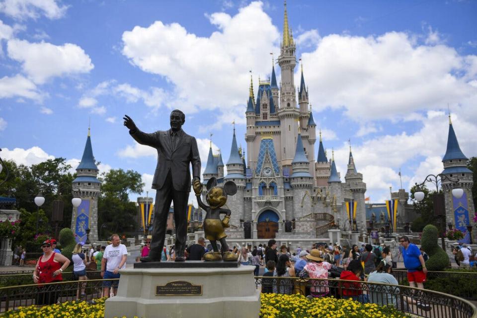 The "Partners" statue sits in front of Cinderella's Castle at Magic Kingdom on Wednesday, May 1, 2019 at Disney World in Orlando, Florida.