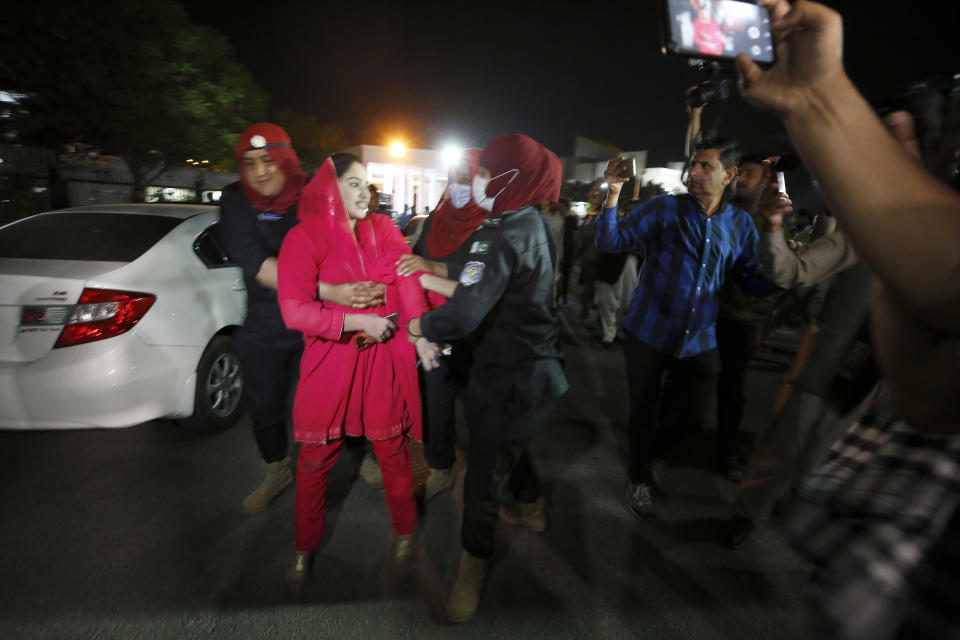 Police officers detain a supporter of Pakistan's Prime Minister Imran Khan outside the National Assembly after a no-confidence vote, in Islamabad, Pakistan, early Sunday, April 10, 2022. Pakistan's political opposition ousted the country's embattled prime minister in a no confidence vote on Saturday, which they won after several of Imran Khan's allies and a key coalition party deserted him. (AP Photo/Anjum Naveed)