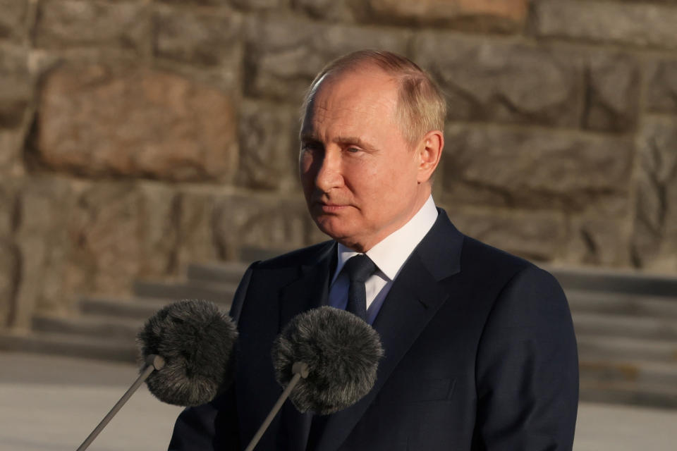 Russian President Vladimir Putin gives a speech in front of the monument 