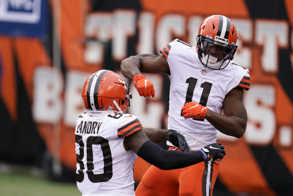 Cleveland Browns' Donovan Peoples-Jones (11) celebrates his touchdown reception with Jarvis Landry (80) during the second half of an NFL football game against the Cincinnati Bengals, Sunday, Oct. 25, 2020, in Cincinnati. (AP Photo/Michael Conroy)