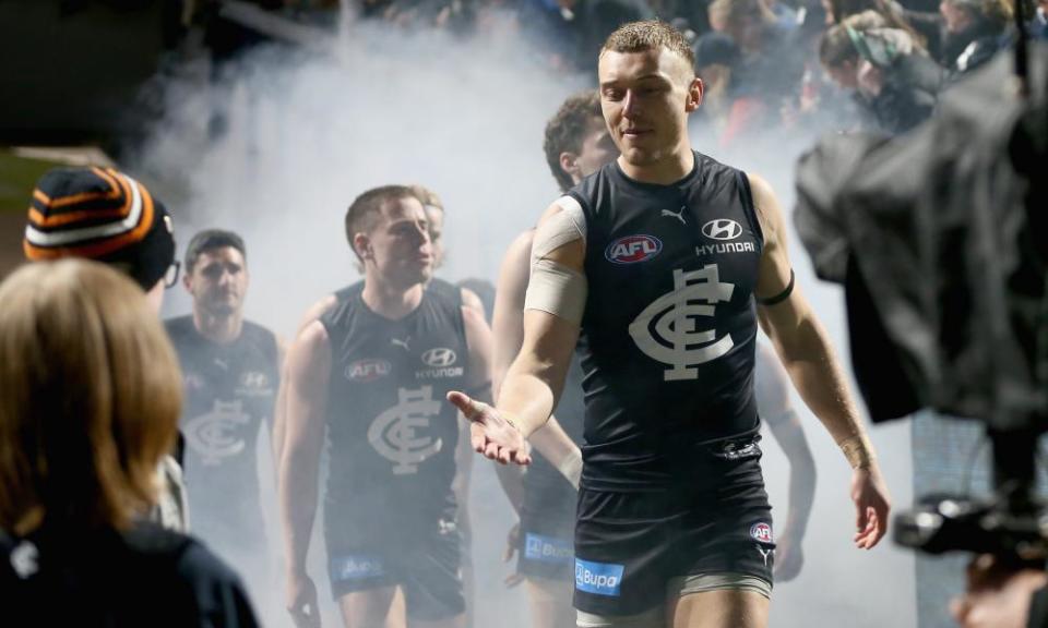 Patrick Cripps leads the Carlton Blues onto the Melbourne Cricket Ground against the Demons.