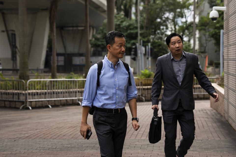 Pro-democracy activist Raymond Chan, left, arrives at the West Kowloon courts as closing arguments open in Hong Kong's largest national security trial of 47 pro-democracy figures in Hong Kong, Wednesday, Nov. 29, 2023. (AP Photo/Louise Delmotte)