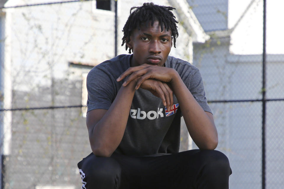 Jamari Shaw, 16, poses for a portrait in his East side neighborhood Thursday, May 11, 2023, in Buffalo, N.Y. Shaw is one of many young people who are still nervous in their surroundings since last years racist mass shooting at Tops Market. (AP Photo/Jeffrey T. Barnes)