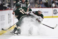 Minnesota Wild center Mason Shaw, left, and Arizona Coyotes center Alex Kerfoot (15) compete for the puck during the second period of an NHL hockey game Tuesday, March 12, 2024, in St. Paul, Minn. (AP Photo/Matt Krohn)