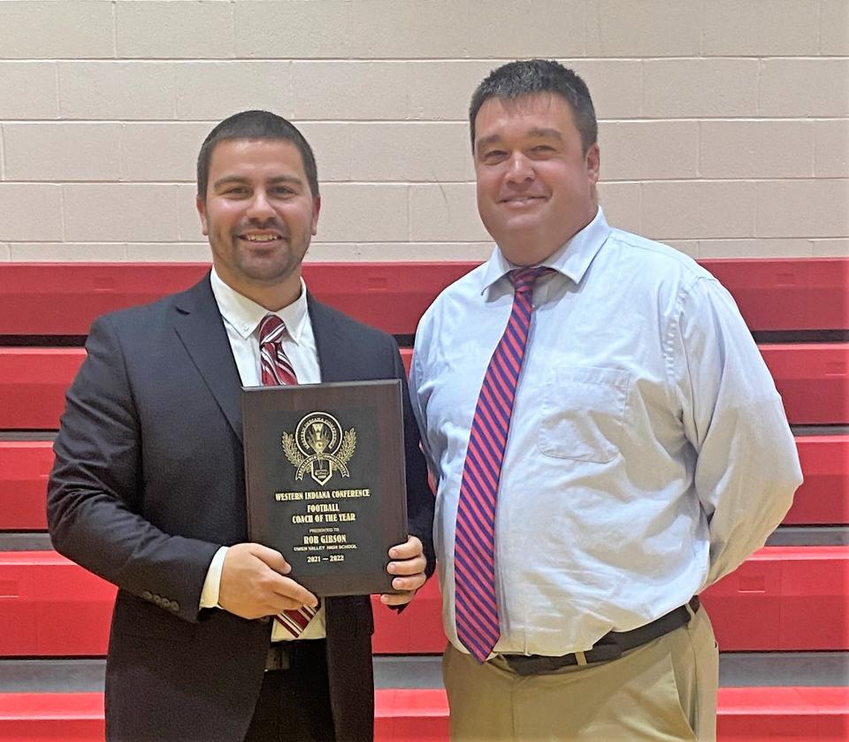 Owen Valley varsity football coach Rob Gibson was named Coach of the Year in the Western Indiana Conference for the 2021 football season. He is shown with OVHS Athletic Director Brad Greene.