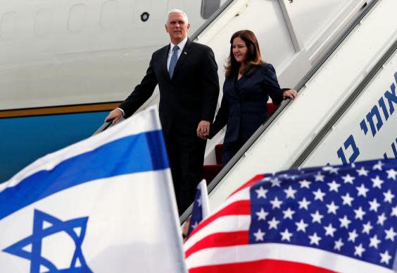 US Vice President Mike Pence (L) and his wife Karen disembark from a plane upon their arrival at Ben Gurion International Airport to attend the World Holocaust memorial (Photo by AMMAR AWAD/POOL/AFP via Getty Images)