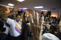 Supporters celebrate at the Future Forward Party headquarters in Bangkok, Thailand, Tuesday, Jan. 21, 2020. Thailand's Constitutional Court acquitted the country's third-biggest political party of seeking the overthrow of the country's constitutional monarchy. The court ruled Tuesday that the Future Forward Party showed no intention of committing the offense, and that the complaint had not been filed according to the correct legal procedure. (AP Photo/Sakchai Lalit)