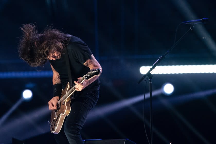 A man shredding a guitar onstage