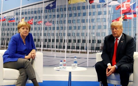 Keeping their distance; Angela Merkel meets with Donald Trump during the Nato summit in Brussels - Credit: REUTERS