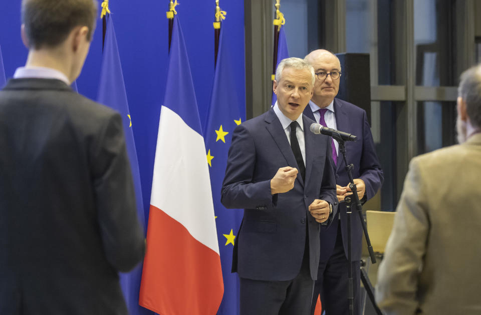 French Finance Minister Bruno Le Maire, left, and European Trade Commissioner Phil Hogan attend a media conference after their meeting in Paris, Tuesday, Jan. 7, 2020. The talks are focused on U.S. tariffs on French wine and other goods. (AP Photo/Michel Euler)