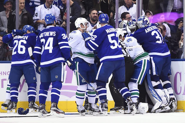 Vancouver Canucks and Toronto Maple Leafs players brawl during the third period of an NHL hockey game Saturday, Nov. 5, 2016, in Toronto. (Frank Gunn/The Canadian Press via AP)