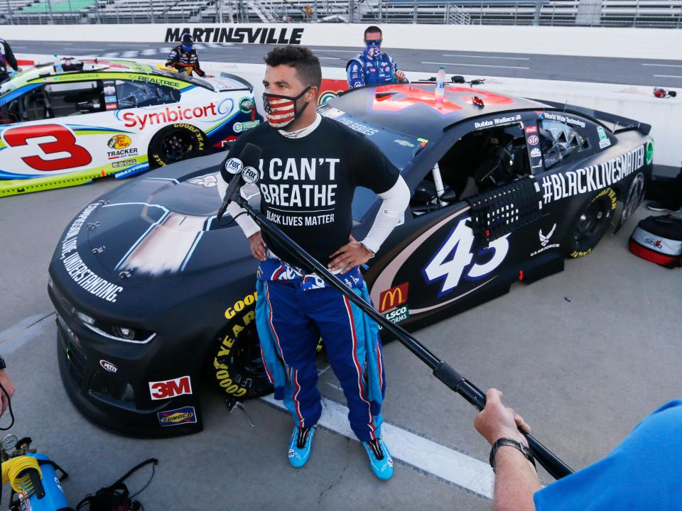 Driver Bubba Wallace is interviewed before a NASCAR Cup Series auto race Wednesday, June 10, 2020, in Martinsville, Va. (AP Photo/Steve Helber)
