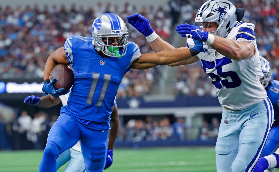 Detroit Lions wide receiver Kalif Raymond runs with the ball as Dallas Cowboys linebacker Leighton Vander Esch defends during the first quarter at AT&T Stadium, Oct. 23, 2022 in Arlington, Texas.