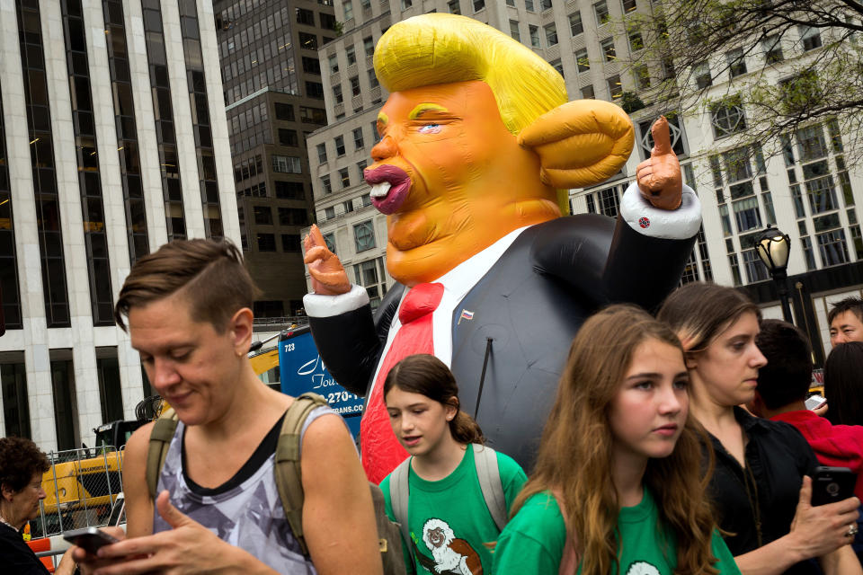 Pedestrians walk past a 15-foot tall inflatable rat in the likeness of U.S. President Donald Trump at the corner of Fifth Avenue and 59th Street up the road from Trump Tower, August 14, 2017 in New York City.&nbsp;