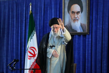 Iran's Supreme Leader Ayatollah Ali Khamenei waves his hand as he arrives to deliver a speech during a ceremony marking the 30th death anniversary of the founder of the Islamic Republic Ayatollah Ruhollah Khomeini in Tehran