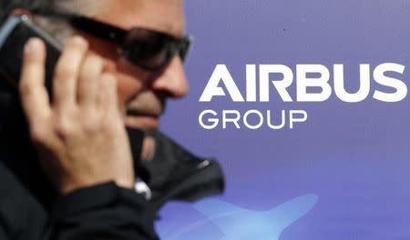 A man makes a phone call next to the logo of Airbus Group during the e-Aircraft Day at the Bordeaux Merignac airport, southwestern France, April 25, 2014. REUTERS/Regis Duvignau (FRANCE - Tags: TRANSPORT BUSINESS LOGO) POLITICS)