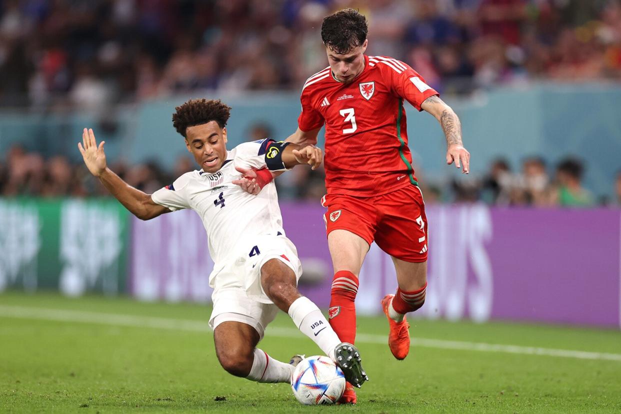 Neco Williams of Wales is tackled by Tyler Adams of United States during the FIFA World Cup Qatar 2022 Group B match between USA and Wales at Ahmad Bin Ali Stadium on November 21, 2022 in Doha, Qatar.