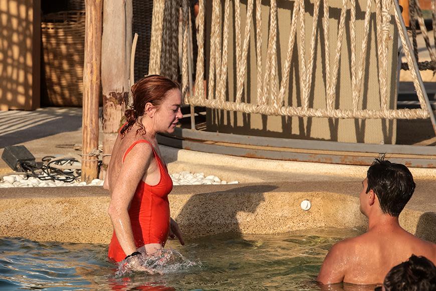 Lindsay Lohan soaks up the sun in a red swimsuit