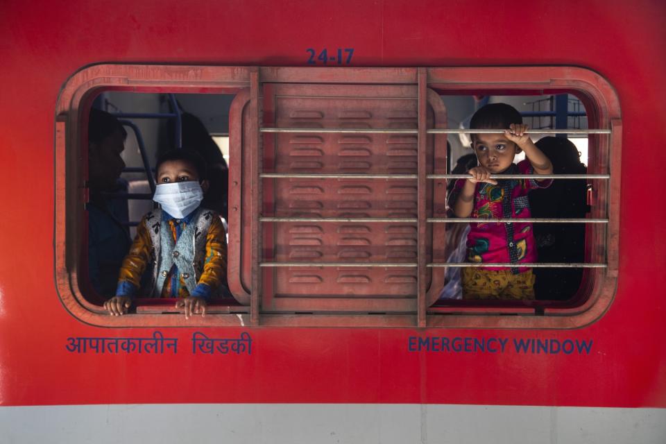 Boys look out a train window.