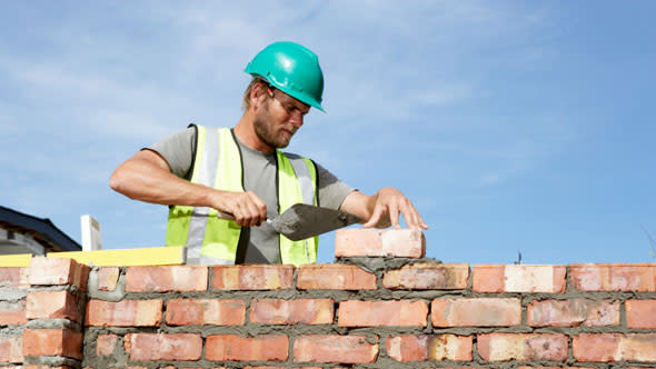 Man laying bricks