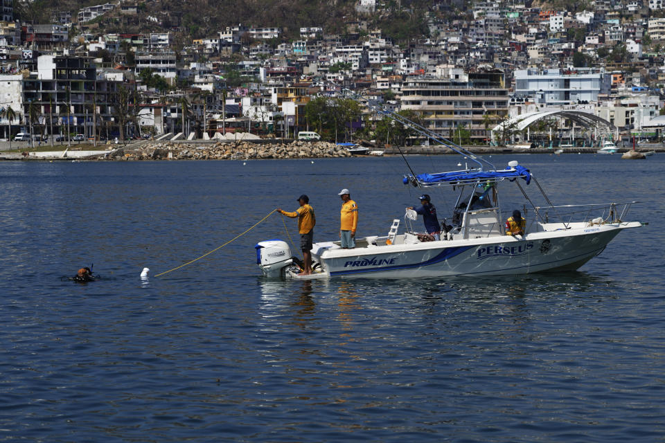 Members of the Navy and the Urgent Medical Rescue Squadron (ERUM) dive in search of bodies, weeks after the passing of Hurricane Otis, in Acapulco, Mexico, Saturday, Nov. 11, 2023. It was 12:20 a.m. on Oct. 25. when Hurricane Otis made landfall in this Pacific port city as a Category 5 hurricane, leaving 48 dead, mostly by drowning, and 31 missing, according to official figures. Sailors, fishermen and relatives of crew members believe that there may be more missing because sailors often go to take care of their yachts when a storm approaches. (AP Photo/Marco Ugarte)