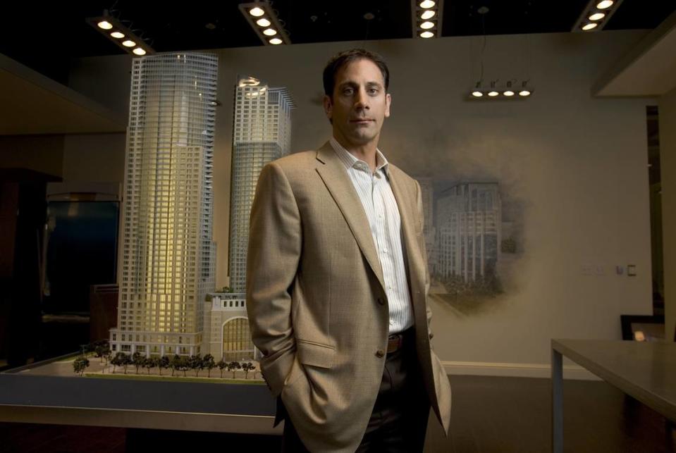 John Saca, president of Saca Development, stands next to a model of his proposed 53-story twin towers high-rise in 2006. The 2.1 million-square-foot project was planned to be 600 feet tall.