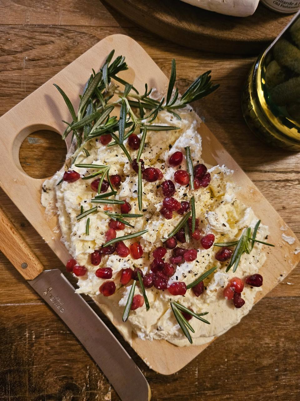 A butter board made by Courier Journal dining columnist Dana McMahan is topped with pomegranate seeds and fresh rosemary.