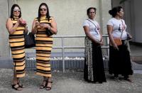 Lakshika and Devika (55), look on during an event to attempt to break the world record for the biggest gathering of twins in Colombo