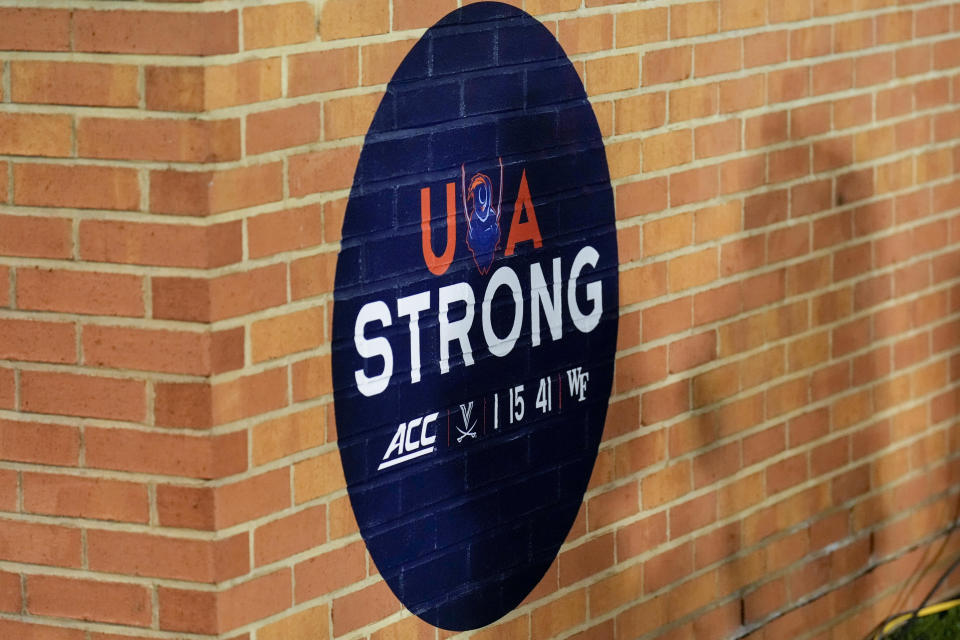 Nov 19, 2022; Winston-Salem, North Carolina, USA;  A memorial sign honoring the three University of Virginia football players who died in a shooting is seen on the sidelines during the first half between the Wake Forest Demon Deacons and the Syracuse Orange at Truist Field. Mandatory Credit: Jim Dedmon-USA TODAY Sports