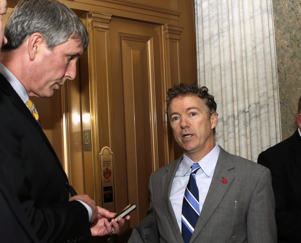 Senator Paul talks to reporters outside of Senate chamber after budget vote on Capitol Hill in Washington