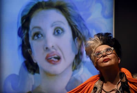 French artist "ORLAN" poses next to a photographic portrait of herself superimposed with Botticelli's Venus at the Victoria and Albert museum in London, Britain, March 2, 2016. REUTERS/Toby Melville