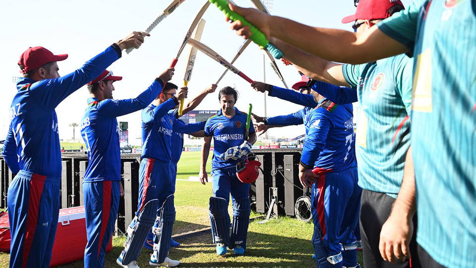 Asghar Afghan, pictured here making his way off the field under a guard of honour.