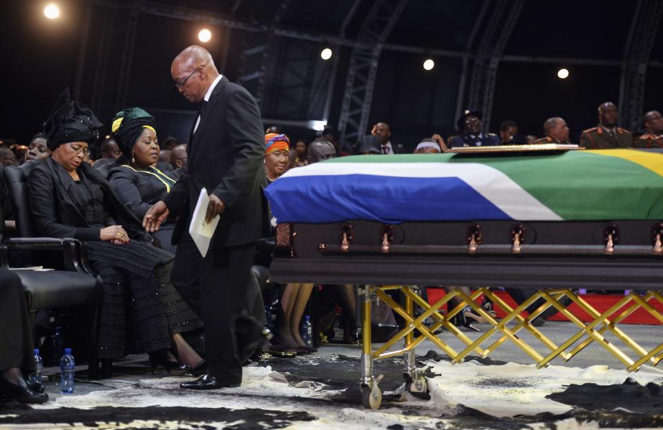 South Africa's President Zuma returns to seat after giving speech at funeral ceremony for former South African President Mandela in Qunu