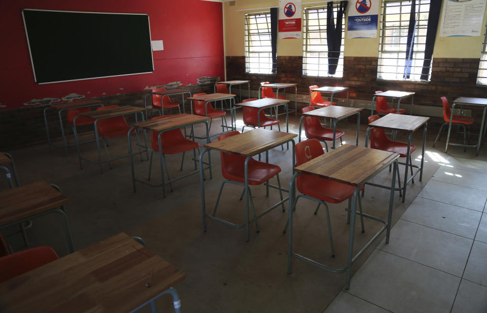 A classroom with safely spaced desks laid out to protect learners against the spread of coronavirus is seen at Mabuya Secondary School in Daveyton east of Johannesburg, South Africa, Wednesday, May 27, 2020, ahead of the June 1, re-opening of Grade 7 and 12 learners to school. (AP Photo/Themba Hadebe)