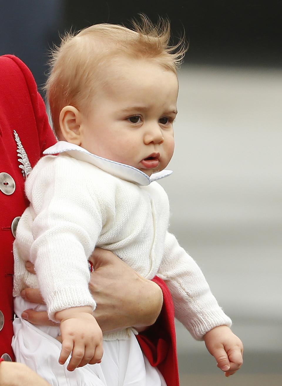 Catherine, the Duchess of Cambridge, holds her son Prince George after disembarking their plane with her husband Britain's Prince William in Wellington April 7, 2014. The Prince and his wife Kate are undertaking a 19-day official visit to New Zealand and Australia with their son George. REUTERS/Phil Noble (NEW ZEALAND - Tags: ENTERTAINMENT ROYALS)