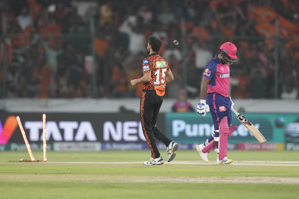 Rajasthan Royals' captain Sanju Samson, right, reacts as he walks back to pavillion after being dismissed by Sunrisers Hyderabad's Bhuvneshwar Kumar, left, during the Indian Premier League cricket match between Sunrisers Hyderabad and Rajasthan Royals in Hyderabad, India, Thursday, May 2, 2024. (AP Photo/Mahesh Kumar A.)