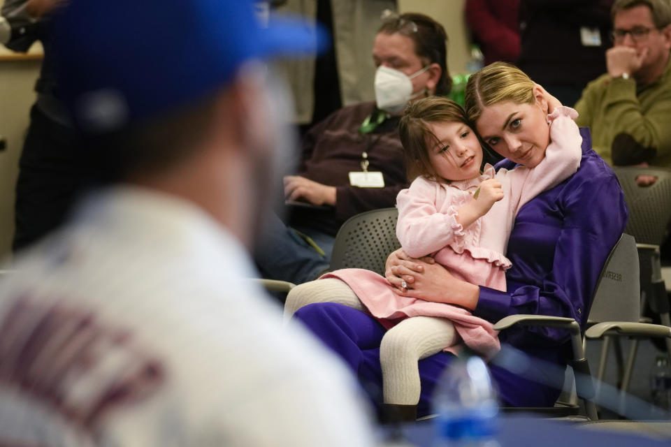 Kate Upton, and her daughter Genevieve, watch as her husband Justin Verlander participates in a news conference at Citi Field, Tuesday, Dec. 20, 2022, in New York. The team introduced Verlander at a news conference after they agreed to a $86.7 million, two-year contract. It's part of an offseason spending spree in which the Mets have committed $476.7 million on seven free agents. (AP Photo/Seth Wenig)